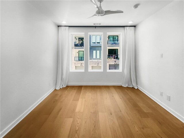 empty room featuring ceiling fan and light hardwood / wood-style floors