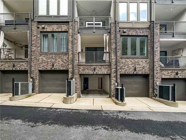 371 Pratt Dr SE Unit 203, Atlanta, GA 30315 - view of property with cooling unit, an attached garage, and driveway