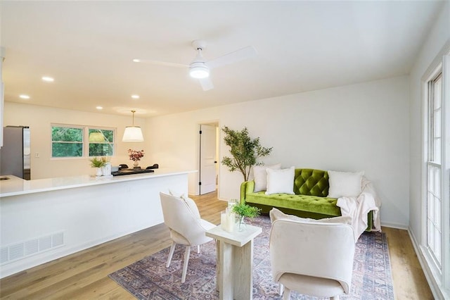 dining room with ceiling fan and light wood-type flooring