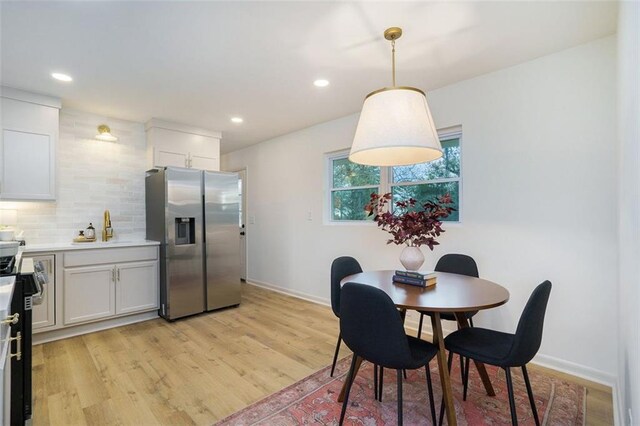 dining area with light hardwood / wood-style flooring