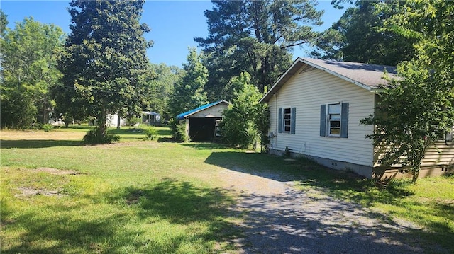 view of side of property with a yard