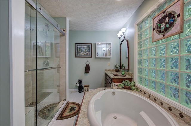 bathroom with separate shower and tub, tile patterned floors, vanity, and a textured ceiling