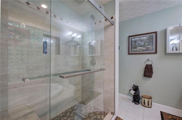 bathroom featuring tile patterned floors, walk in shower, and a textured ceiling