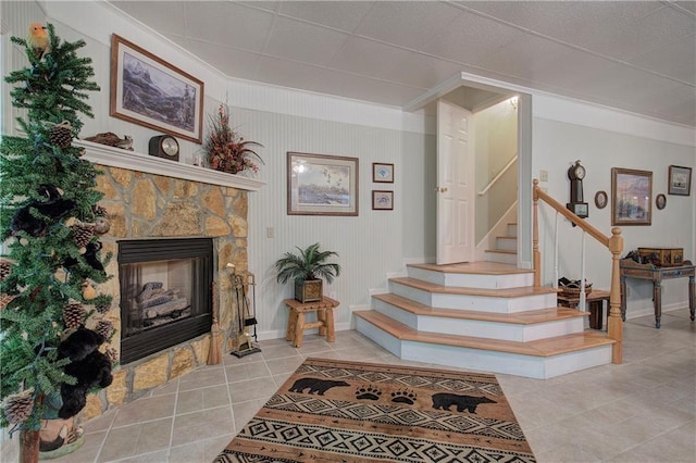 stairs with a fireplace and tile patterned floors