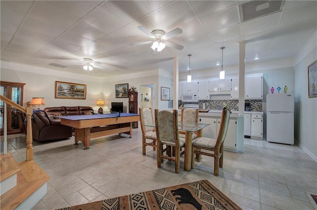 tiled dining space with ceiling fan and pool table