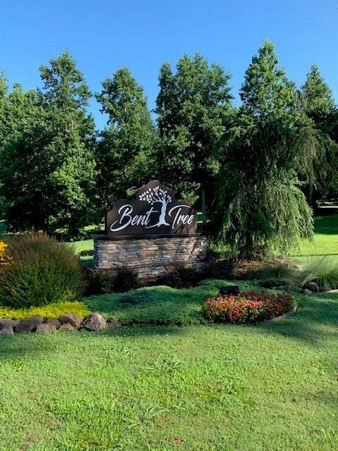community sign featuring a lawn