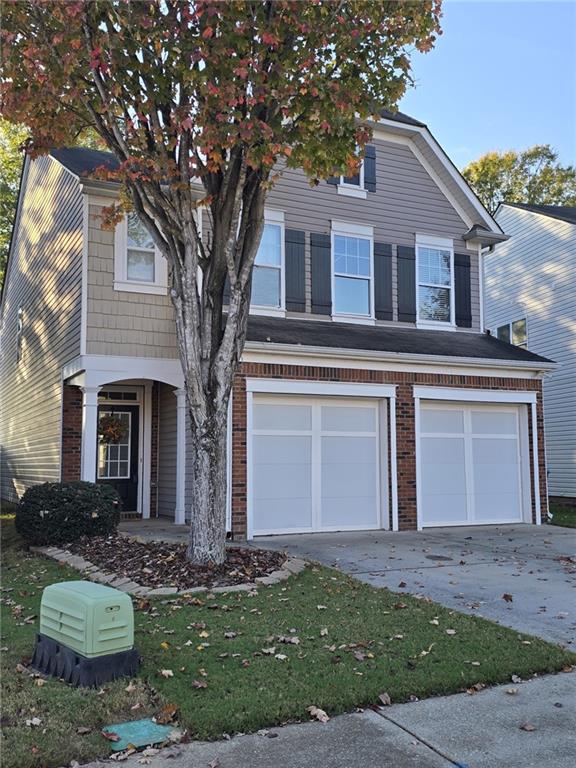 front facade with a front yard and a garage