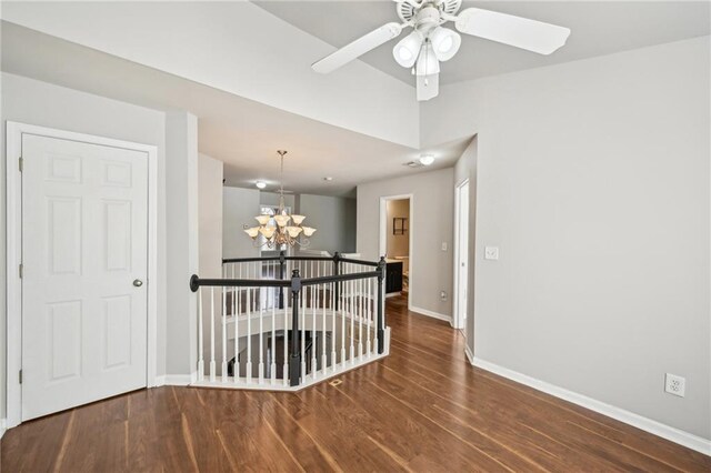 2726 Pierce Brennen Ct, Lawrenceville, GA 30043 - spare room featuring baseboards, wood finished floors, and ceiling fan with notable chandelier