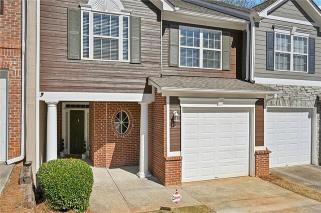 2726 Pierce Brennen Ct, Lawrenceville, GA 30043 - view of property featuring brick siding and a garage