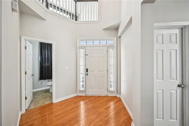 2726 Pierce Brennen Ct, Lawrenceville, GA 30043 - entrance foyer featuring baseboards, light wood-style flooring, and a towering ceiling