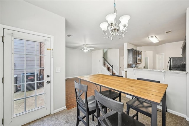 2726 Pierce Brennen Ct, Lawrenceville, GA 30043 - dining area featuring stairway, ceiling fan with notable chandelier, visible vents, and baseboards