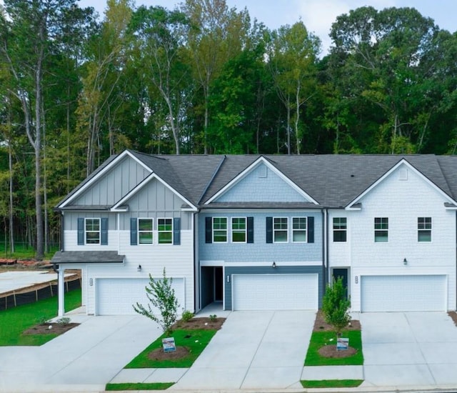 42 Buckingham Ln Unit 233, Hoschton, GA 30548 - view of property featuring board and batten siding, a garage, and driveway