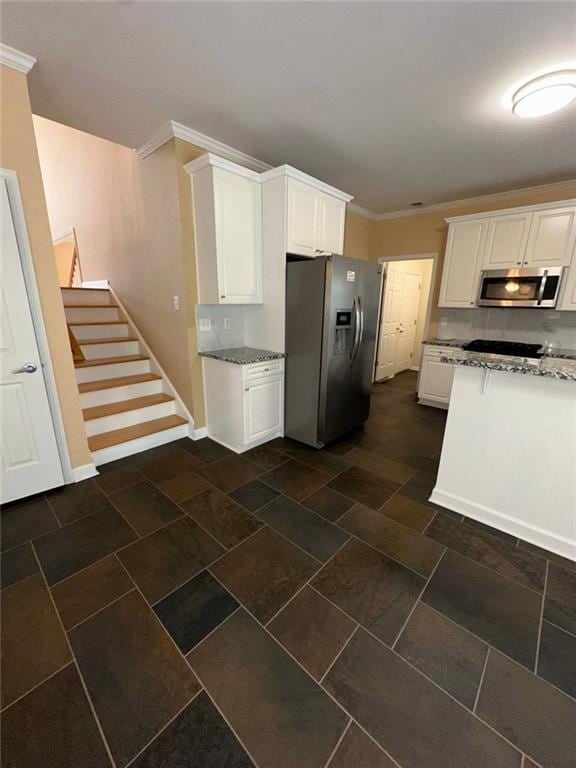3381 Walkers Ridge Rd, Dacula, GA 30019 - kitchen featuring stainless steel appliances, white cabinetry, crown molding, light stone countertops, and baseboards