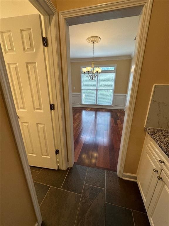 3381 Walkers Ridge Rd, Dacula, GA 30019 - corridor with a chandelier, a decorative wall, a wainscoted wall, and crown molding
