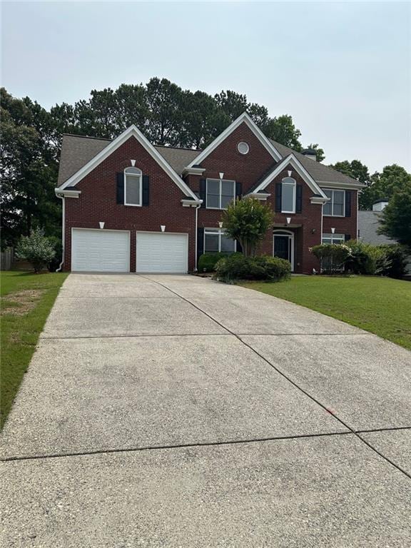 3381 Walkers Ridge Rd, Dacula, GA 30019 - view of front facade featuring an attached garage, brick siding, concrete driveway, and a front yard