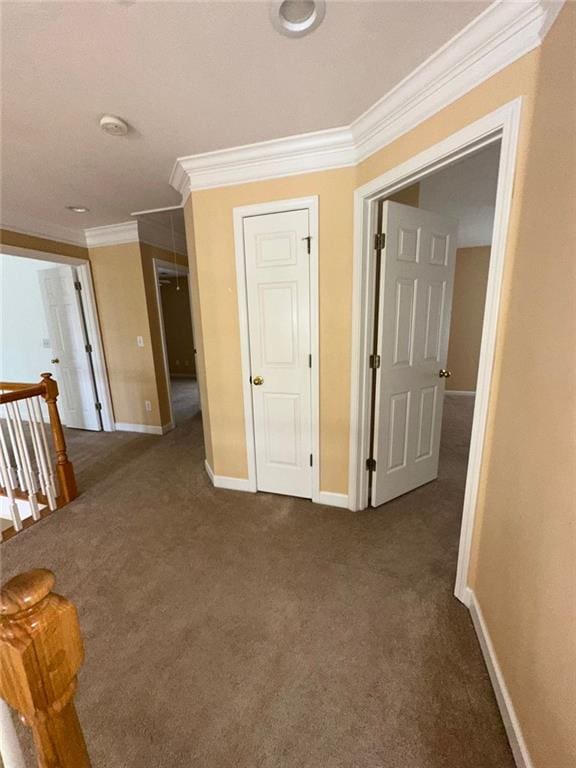 3381 Walkers Ridge Rd, Dacula, GA 30019 - hall featuring an upstairs landing, dark carpet, baseboards, and crown molding