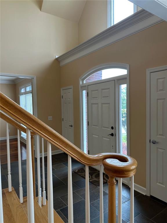 3381 Walkers Ridge Rd, Dacula, GA 30019 - foyer entrance with a towering ceiling, baseboards, and stairs