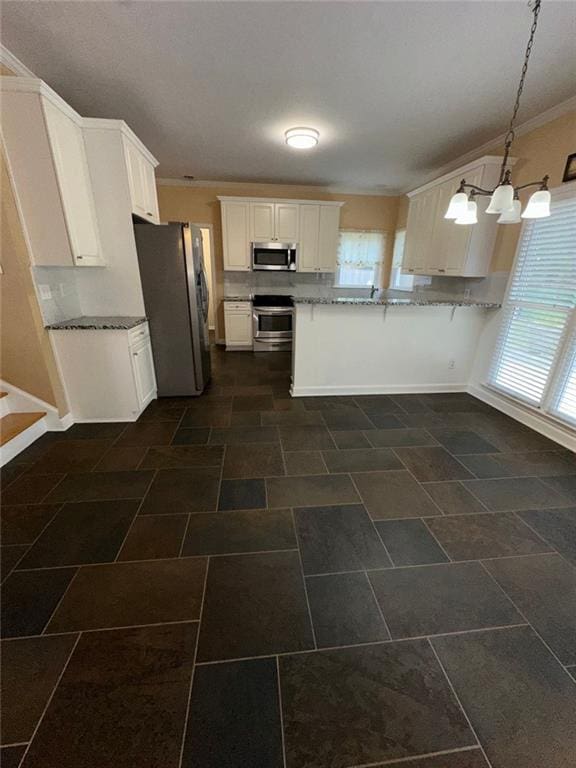 3381 Walkers Ridge Rd, Dacula, GA 30019 - kitchen with appliances with stainless steel finishes, light stone countertops, white cabinetry, a peninsula, and ornamental molding