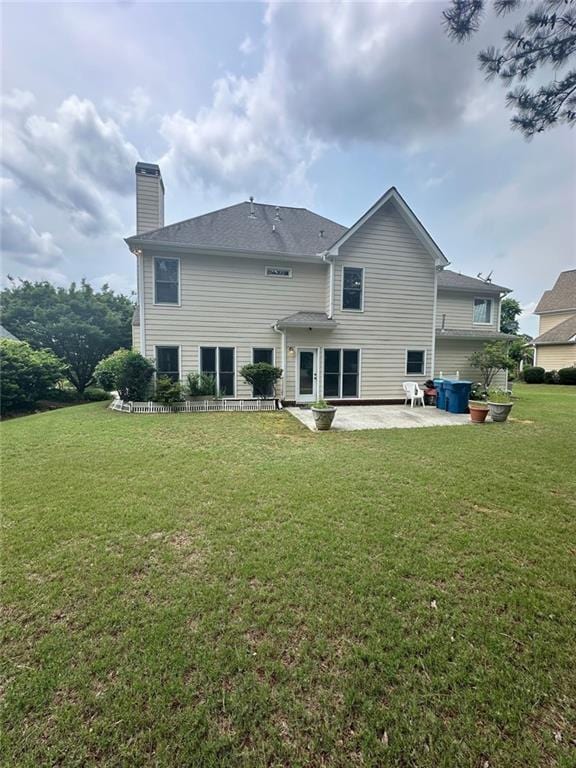 3381 Walkers Ridge Rd, Dacula, GA 30019 - back of house with a patio area, a chimney, and a yard