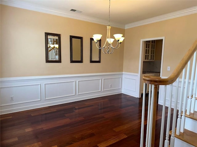 3381 Walkers Ridge Rd, Dacula, GA 30019 - unfurnished dining area with dark wood-style flooring, ornamental molding, a chandelier, a wainscoted wall, and stairway