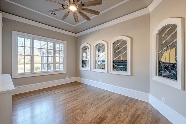 unfurnished room with baseboards, visible vents, ceiling fan, and light wood finished floors