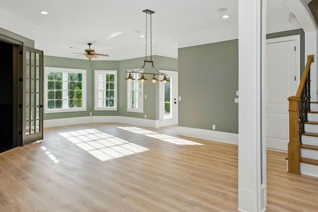 6756 Hedge Row Ln, Gainesville, GA 30506 - unfurnished dining area with ornamental molding, a ceiling fan, stairway, baseboards, and light wood-type flooring