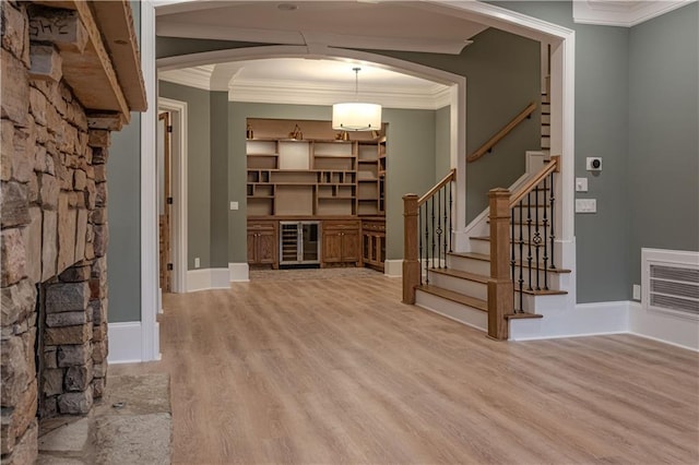 6756 Hedge Row Ln, Gainesville, GA 30506 - foyer entrance with arched walkways, light wood finished floors, crown molding, and stairway