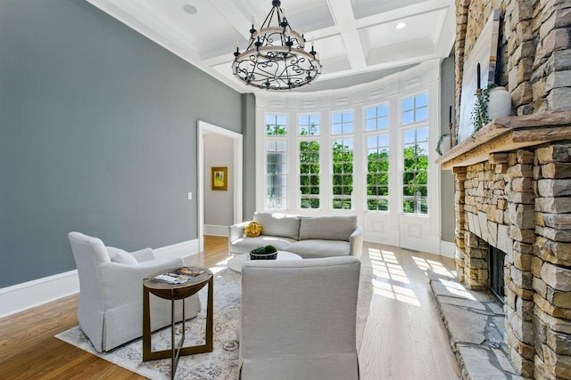 6756 Hedge Row Ln, Gainesville, GA 30506 - living area featuring a towering ceiling, a chandelier, light wood finished floors, a fireplace, and beamed ceiling