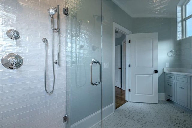 bathroom featuring vanity, baseboards, and a stall shower