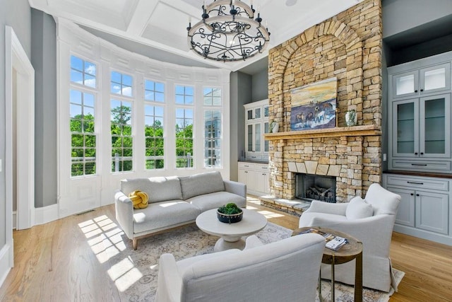 6756 Hedge Row Ln, Gainesville, GA 30506 - living area with light wood-style floors, a fireplace, a towering ceiling, coffered ceiling, and beamed ceiling