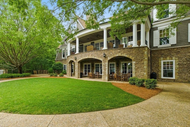 6756 Hedge Row Ln, Gainesville, GA 30506 - rear view of house with a balcony, stone siding, a lawn, and a patio