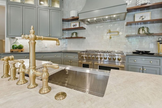 6756 Hedge Row Ln, Gainesville, GA 30506 - kitchen featuring custom range hood, range with two ovens, open shelves, backsplash, and glass insert cabinets
