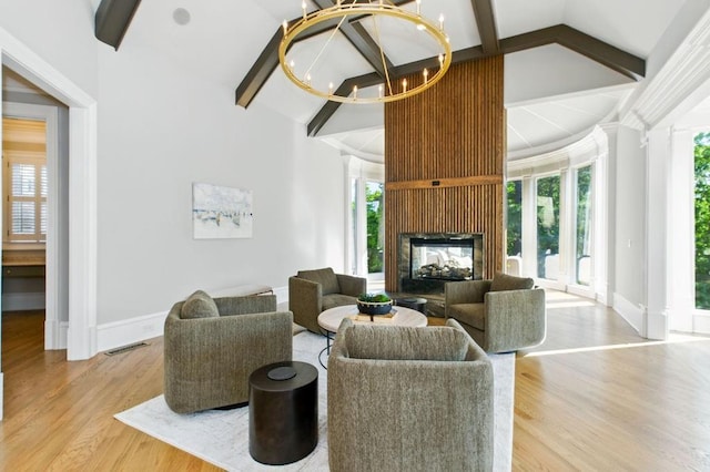 6756 Hedge Row Ln, Gainesville, GA 30506 - living room with a chandelier, wood finished floors, baseboards, and healthy amount of natural light