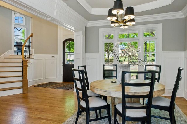 6756 Hedge Row Ln, Gainesville, GA 30506 - dining space featuring a decorative wall, a chandelier, wood finished floors, wainscoting, and stairs