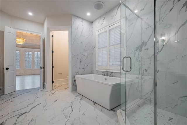 bathroom with a freestanding bath, a chandelier, a marble finish shower, marble finish floor, and recessed lighting