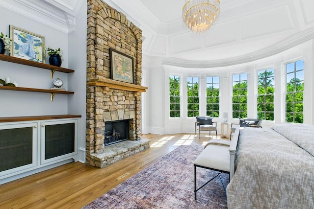6756 Hedge Row Ln, Gainesville, GA 30506 - bedroom with ornamental molding, wood finished floors, a fireplace, and a chandelier