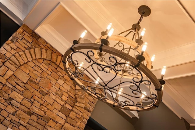 details with a notable chandelier and ornamental molding