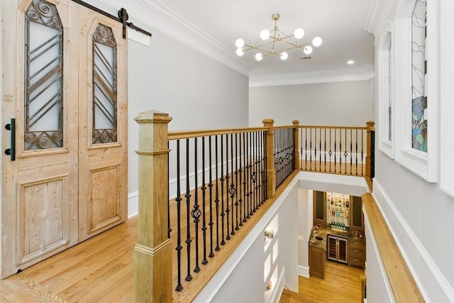 6756 Hedge Row Ln, Gainesville, GA 30506 - staircase with crown molding, wood finished floors, a barn door, and a chandelier
