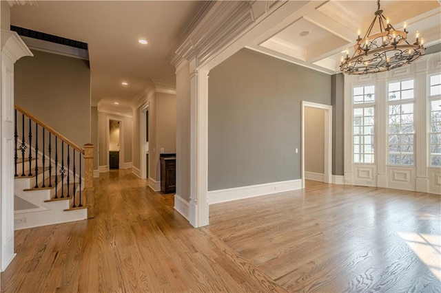 entrance foyer featuring decorative columns, an inviting chandelier, recessed lighting, and light wood-style floors