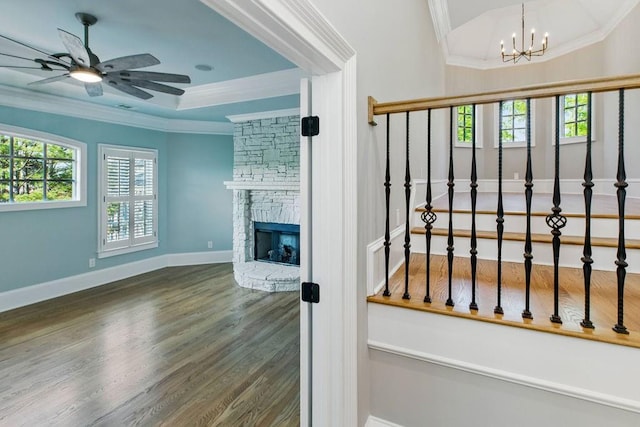 6756 Hedge Row Ln, Gainesville, GA 30506 - unfurnished living room with wood finished floors, a chandelier, a ceiling fan, crown molding, and baseboards