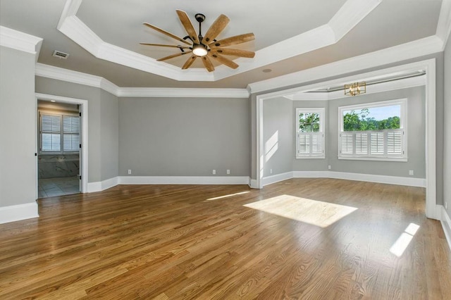 6756 Hedge Row Ln, Gainesville, GA 30506 - unfurnished room featuring a tray ceiling, plenty of natural light, ornamental molding, a ceiling fan, and wood finished floors