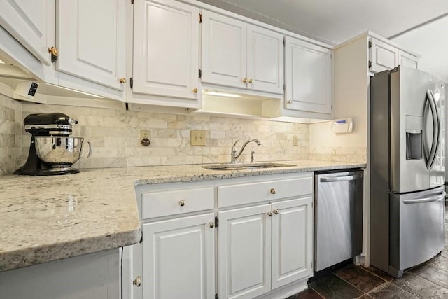 3734 Powers Ferry Rd NW, Atlanta, GA 30342 - kitchen featuring appliances with stainless steel finishes, a sink, white cabinets, and decorative backsplash