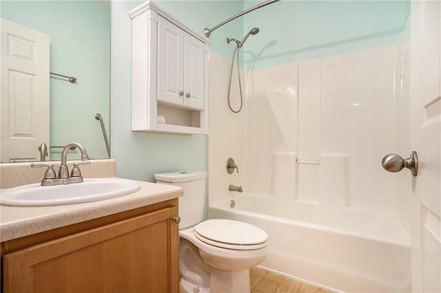 full bathroom featuring hardwood / wood-style flooring, shower / bathtub combination, vanity, and toilet