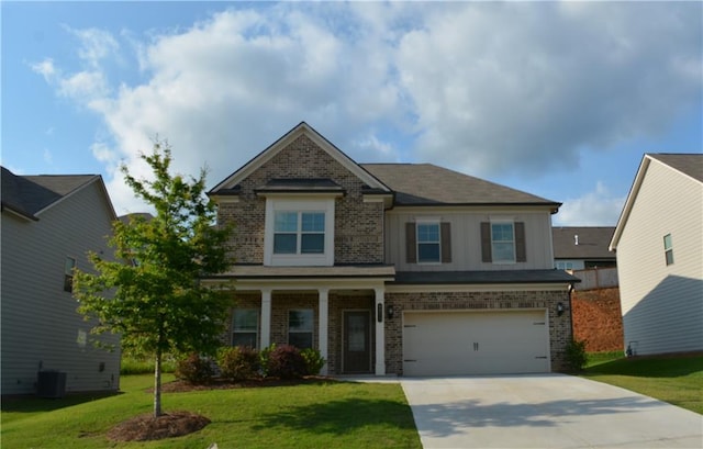 craftsman inspired home with a front lawn, cooling unit, and a garage