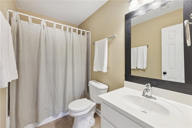 bathroom with vanity, walk in shower, tile patterned floors, and toilet