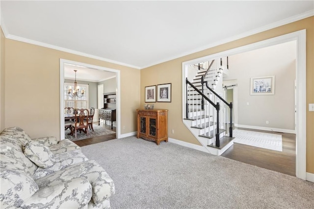 living room featuring carpet floors, ornamental molding, and a chandelier