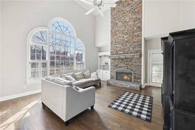 living room with a healthy amount of sunlight, dark hardwood / wood-style floors, and a fireplace