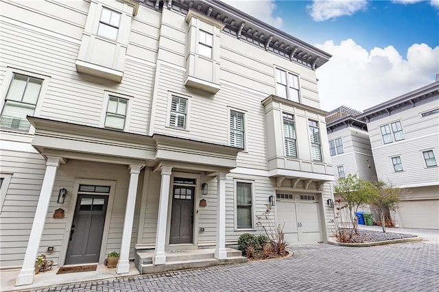 view of front of home featuring decorative driveway and an attached garage