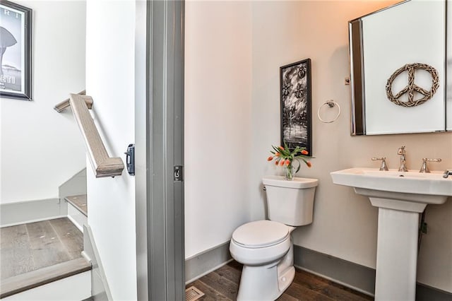 bathroom with visible vents, wood finished floors, toilet, and baseboards