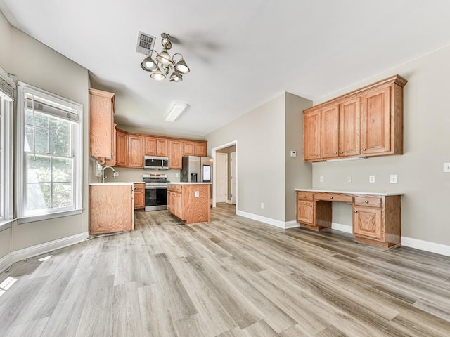 4601 Ethel Springs Trl SW, Mableton, GA 30126 - kitchen with stainless steel appliances, light countertops, light wood-type flooring, baseboards, and a center island